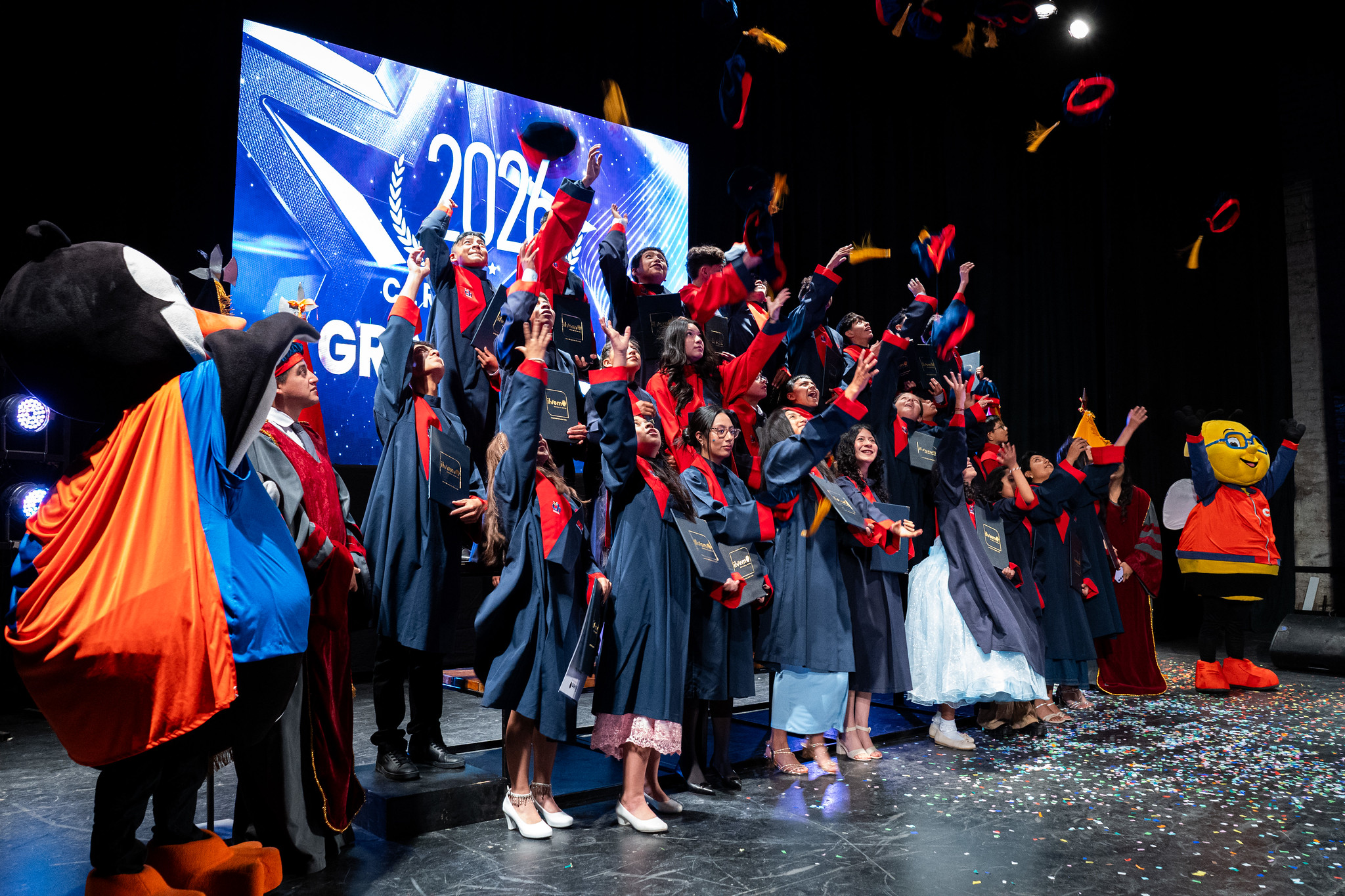 Jóvenes graduados de ILVEM celebrando en el escenario